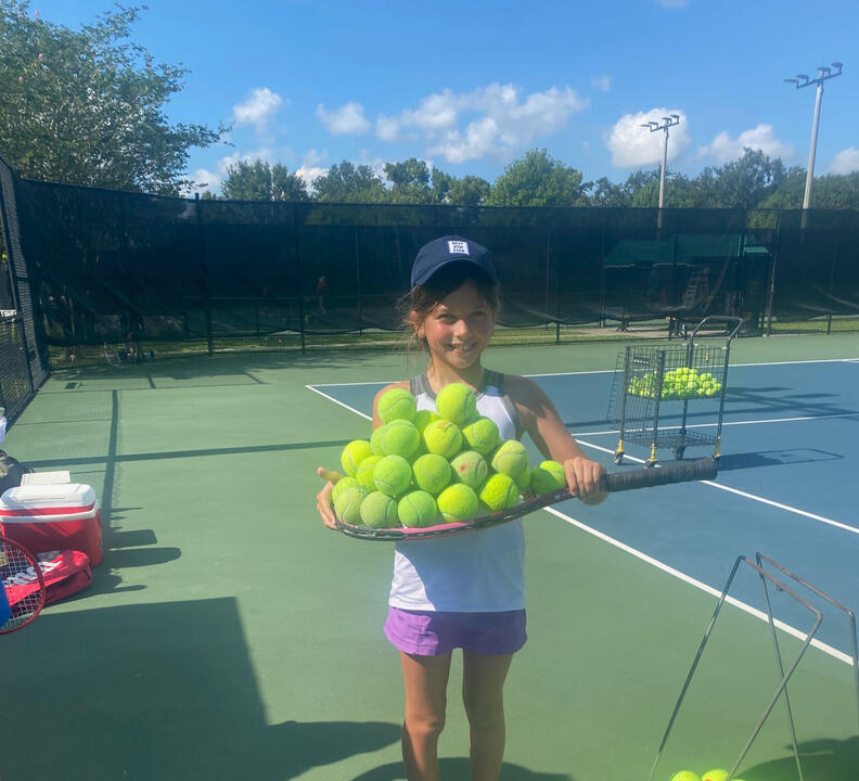 Girl with Tennis Balls on Racket